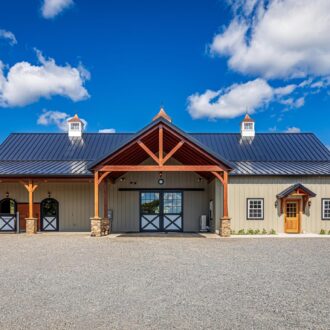 Barn with sliding barn doors, carriage doors, and Dutch windows. Includes protective grills and customizable finishes.