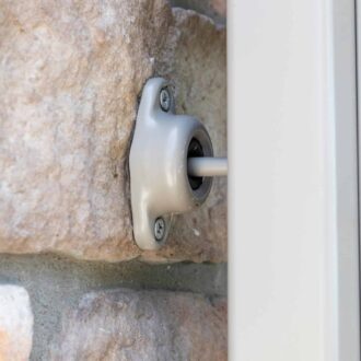 Wall-attached suction cup holder, showcasing a sturdy stone finish and sleek metal hardware.