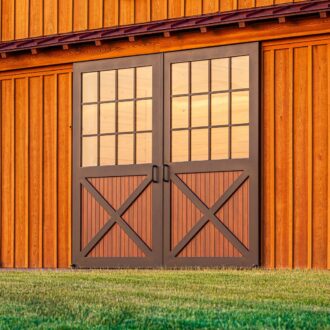 Exterior of a barn with sliding doors featuring a custom faux wood powder coat finish.