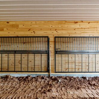 Protective stall grills with mesh, wooden barn interior, showcasing customizable finish options and colors.