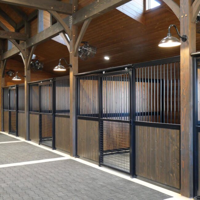 Stall fronts with protective grills, and sliding stall doors.