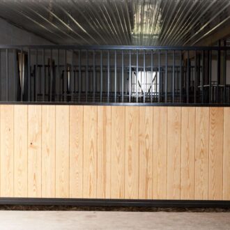 A wood-covered horse stall panel