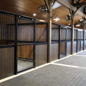 Horse stable with wooden and metal stall fronts and partitions