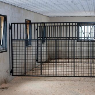A mesh horse stall divider