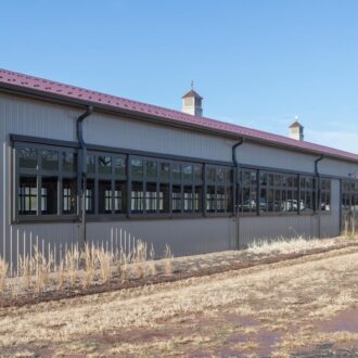 Large building facade with black arena windows, showcasing modern finish and ample natural light options.