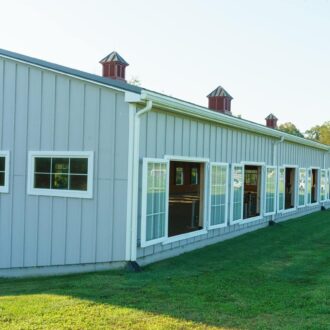 Barn with sliding arena windows, showcasing customizable finish options.