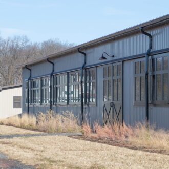 Large building facade with black arena windows, showcasing modern finish and ample natural light options.