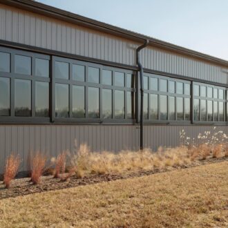 Large building facade with black arena windows, showcasing modern finish and ample natural light options.