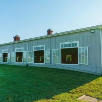 Large, open arena windows on barn, rider inside. Custom finishes available. Perfect for ventilation and natural light.