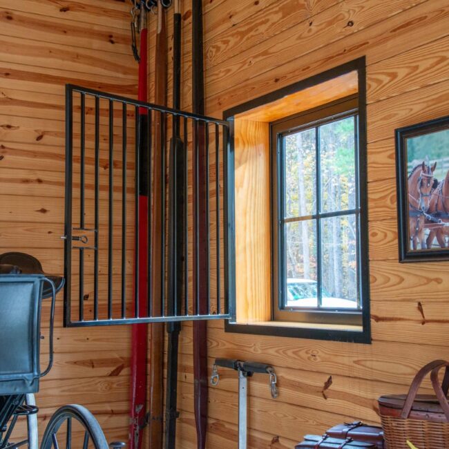 Dutch window with protective grill, wood finish, basket on the floor.