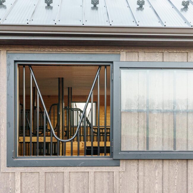Dutch window with protective grill, featuring customizable finishes and color options.