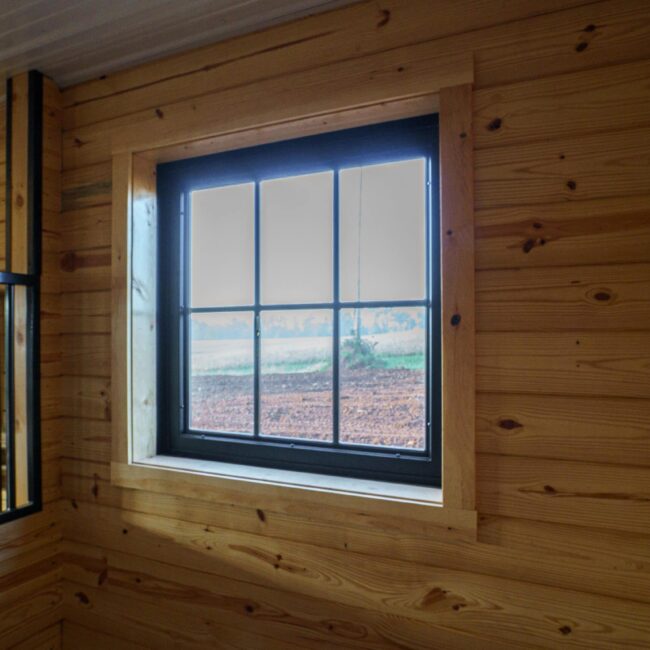 Wood interior featuring a black Dutch window with natural light; ideal for barn or loft settings.