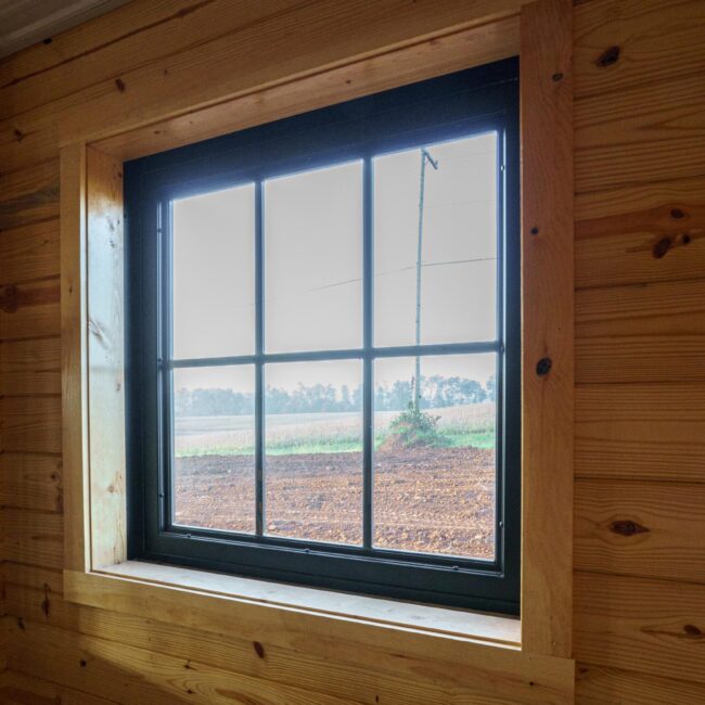 Wood interior featuring a black Dutch window with natural light; ideal for barn or loft settings.