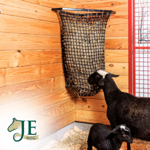Black mesh haynet hay feeder on wooden wall. Ideal for easy feeding in stalls for horses, sheep, and other livestock.