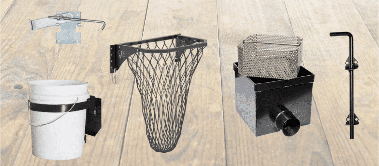 Assorted barn accessories: bucket holder, net basket, metal vent, and hook latch on wood background.